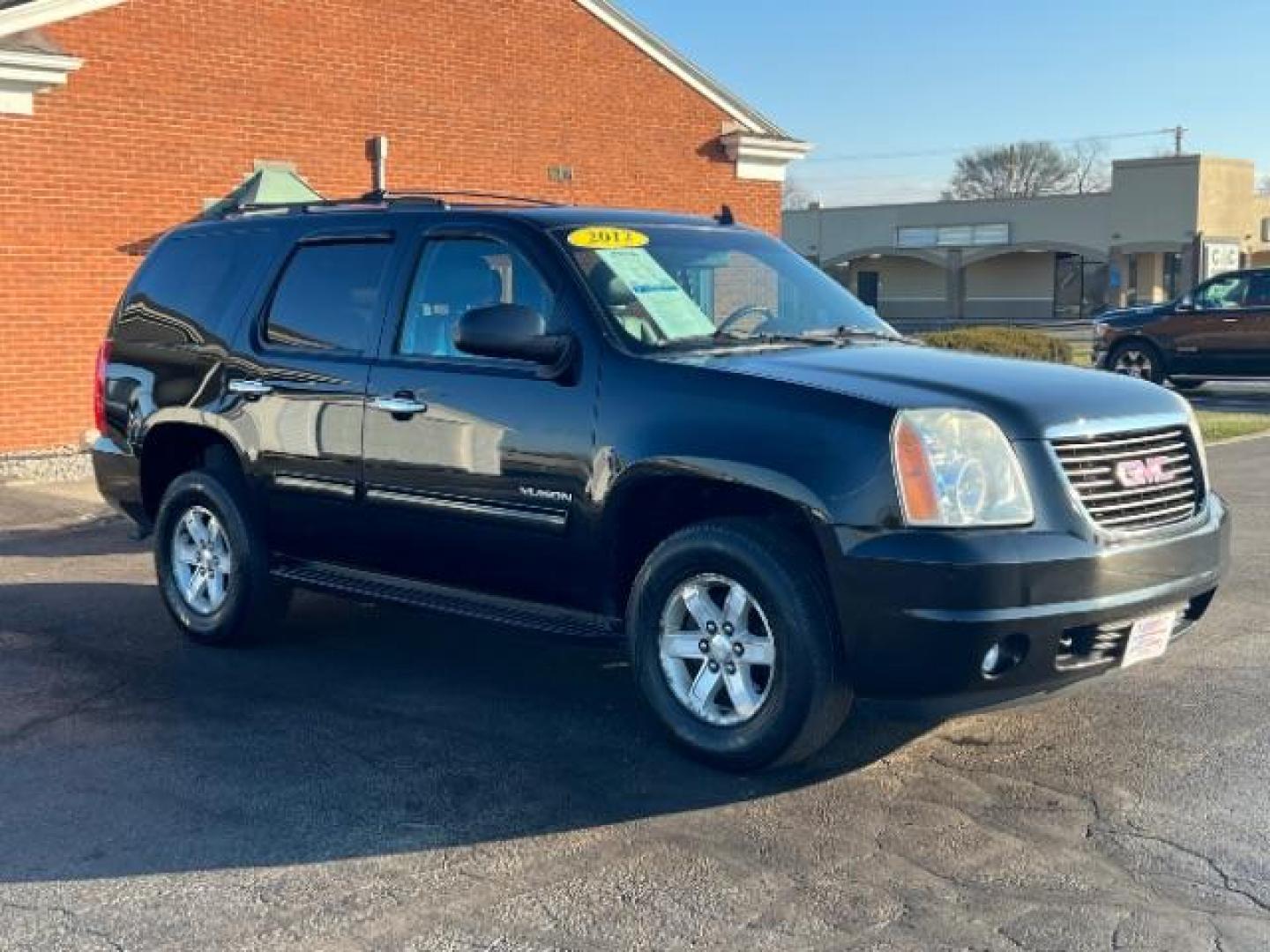 2012 Onyx Black GMC Yukon SLT1 4WD (1GKS2CE03CR) with an 5.3L V8 OHV 16V FFV engine, 6-Speed Automatic transmission, located at 1951 S Dayton Lakeview Rd., New Carlisle, OH, 45344, (937) 908-9800, 39.890999, -84.050255 - Photo#0