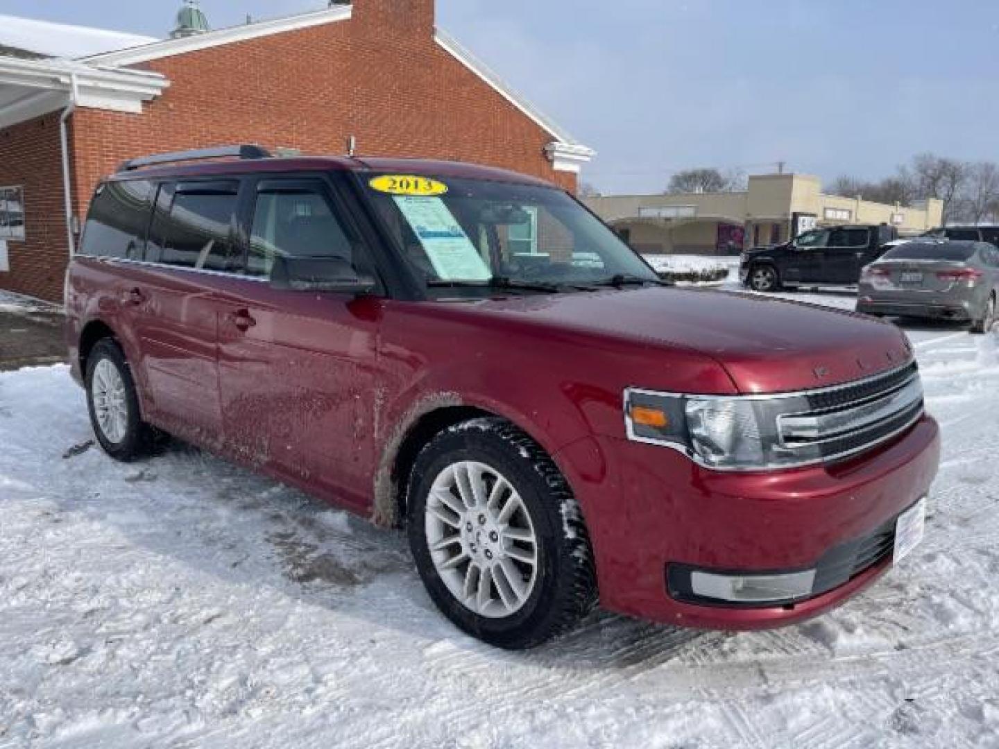 2013 Ruby Red Metallic Tinted Ford Flex SEL FWD (2FMGK5C84DB) with an 3.5L V6 DOHC 24V engine, 6-Speed Automatic Overdrive transmission, located at 1099 N County Rd 25A , Troy, OH, 45373, (937) 908-9800, 40.057079, -84.212883 - Photo#0