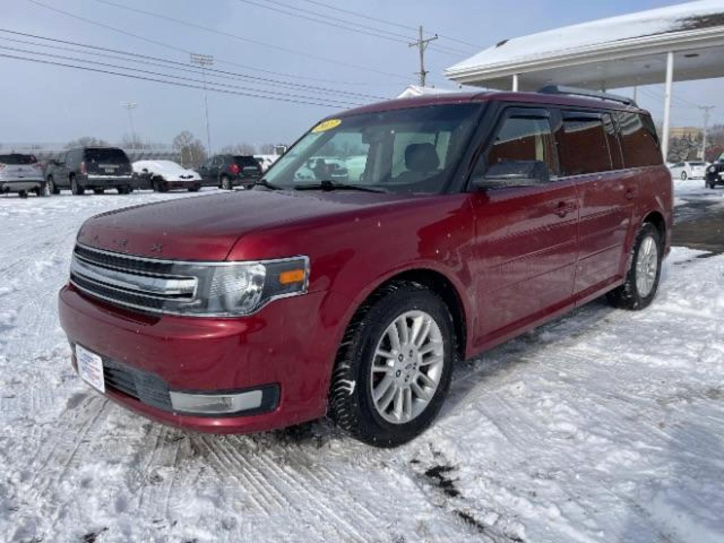 2013 Ruby Red Metallic Tinted Ford Flex SEL FWD (2FMGK5C84DB) with an 3.5L V6 DOHC 24V engine, 6-Speed Automatic Overdrive transmission, located at 1099 N County Rd 25A , Troy, OH, 45373, (937) 908-9800, 40.057079, -84.212883 - Photo#1