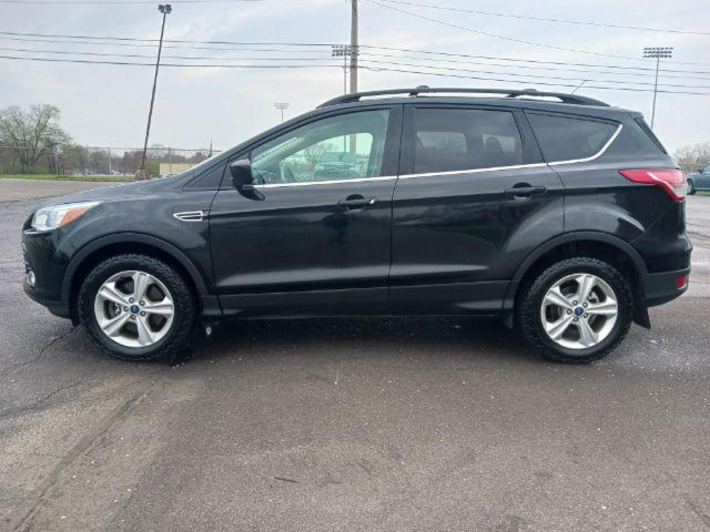 2014 Tuxedo Black Ford Escape SE 4WD (1FMCU9G99EU) with an 2.0L L4 DOHC 16V engine, 6-Speed Automatic transmission, located at 4508 South Dixie Dr, Moraine, OH, 45439, (937) 908-9800, 39.689976, -84.218452 - Photo#3