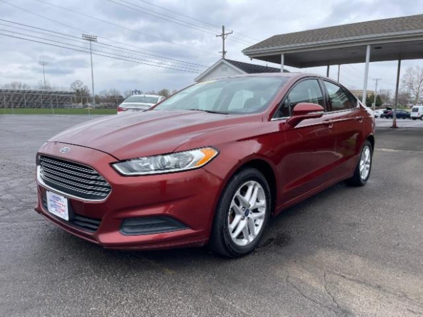 2014 Ruby Red Met Tinted CC Ford Fusion SE (3FA6P0H74ER) with an 2.5L L4 DOHC 16V engine, located at 1099 N County Rd 25A , Troy, OH, 45373, (937) 908-9800, 40.057079, -84.212883 - Photo#1